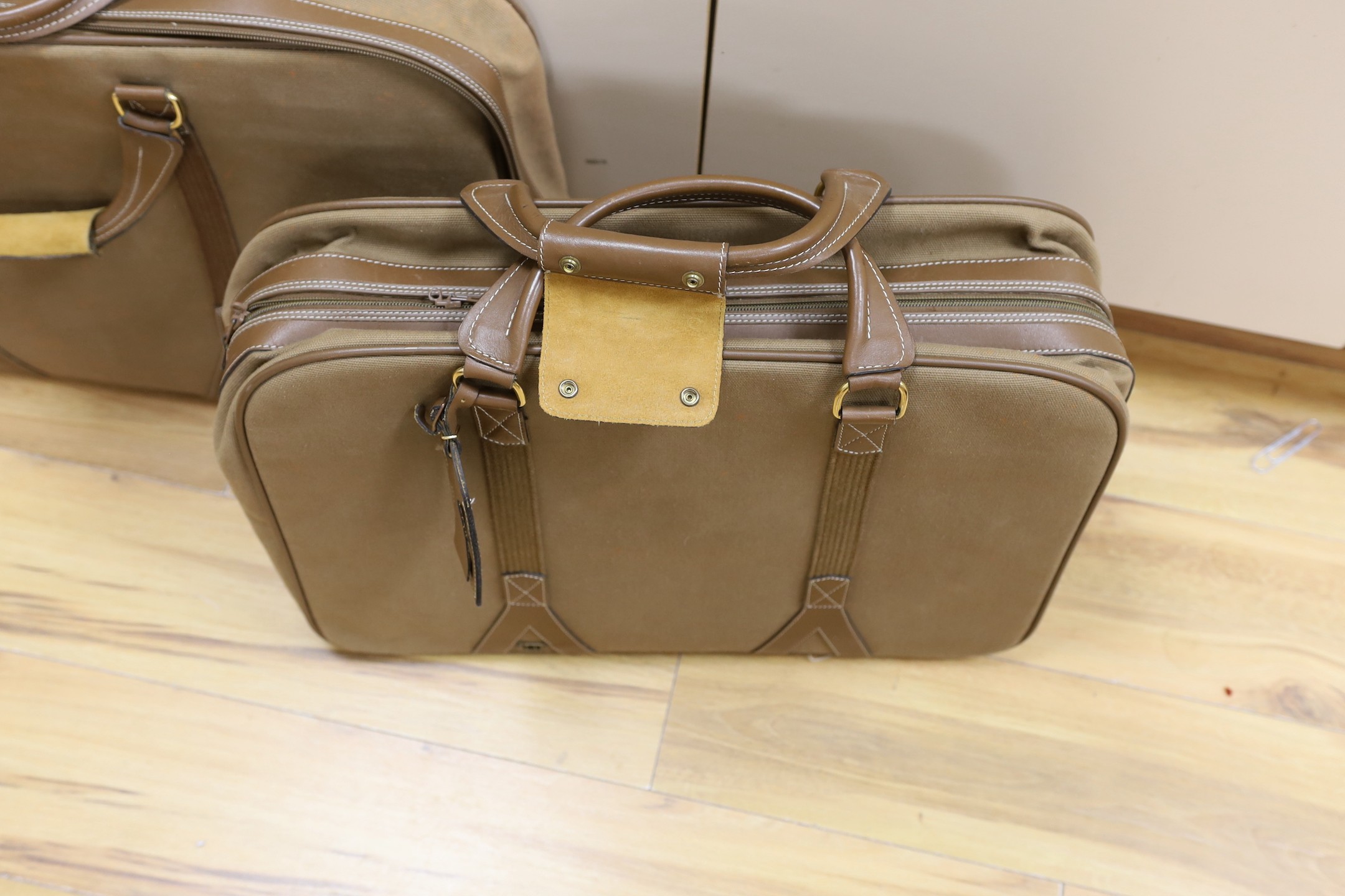 Two 1980's soft canvas Dunhill suit cases, largest 65 cms wide x 42 ms high.